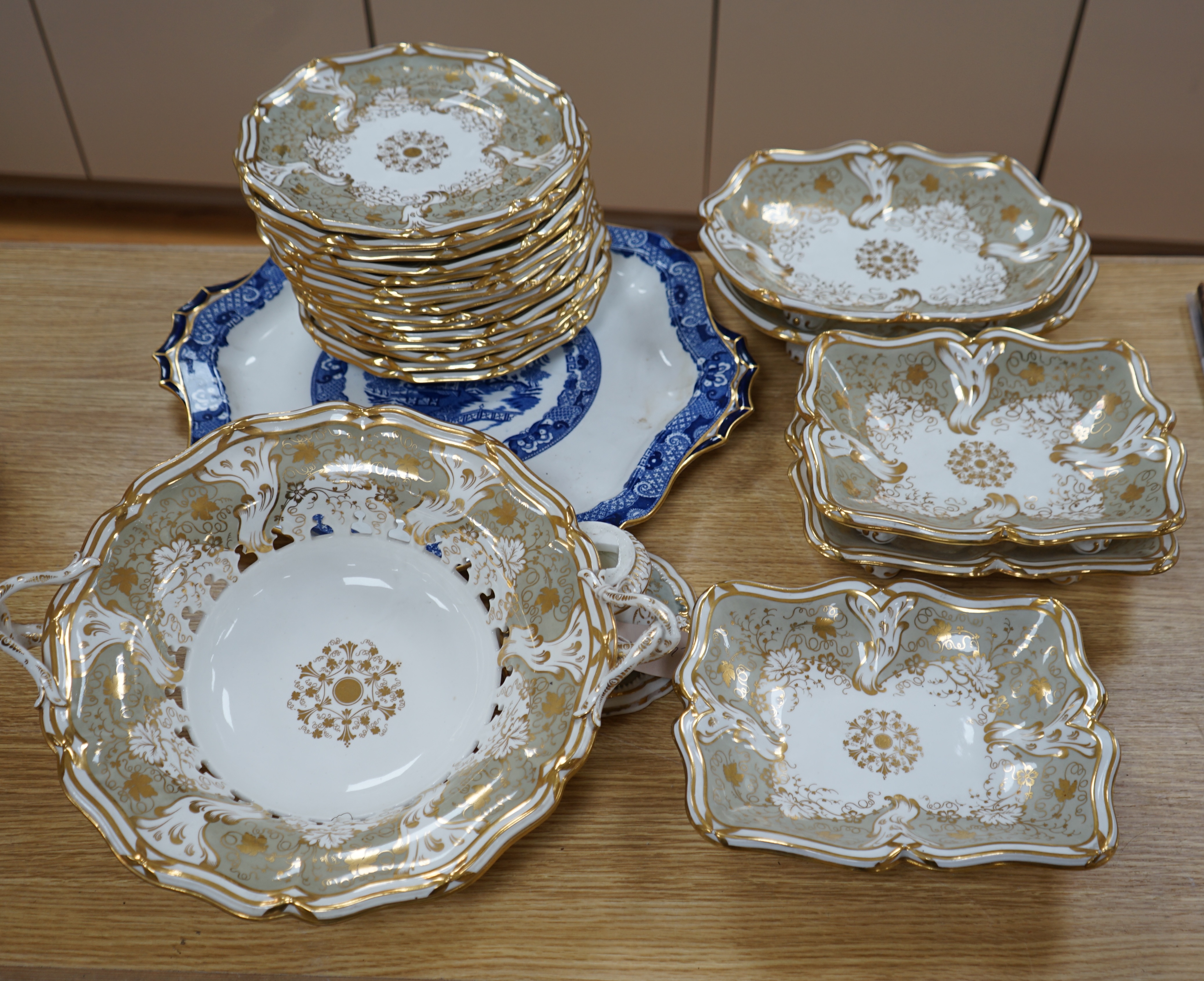 A Davenport part grey and gilt dessert service, together with a blue and white circular serving dish, dish 43cm wide. Condition - comport base broken